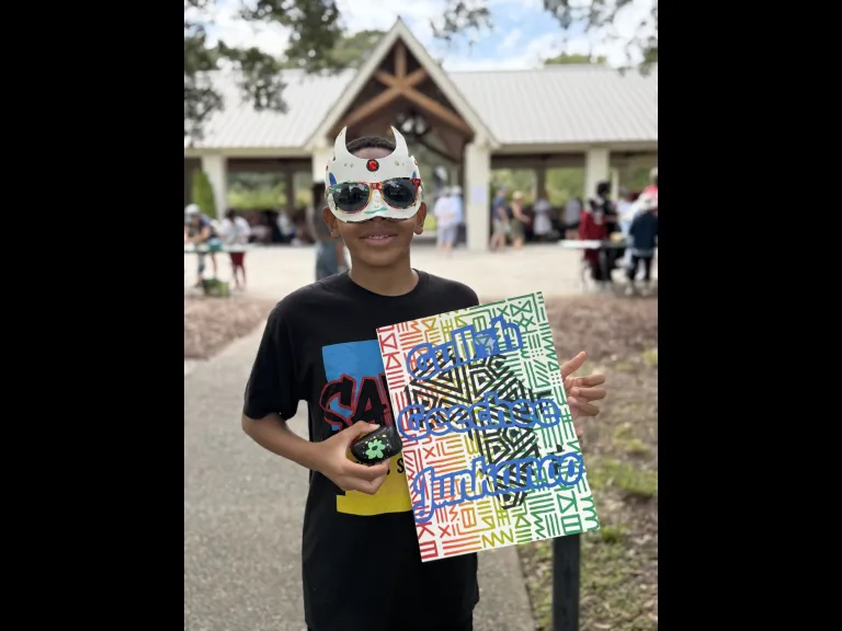 Gullah Geechee Junkanoo kid holding a crafted print