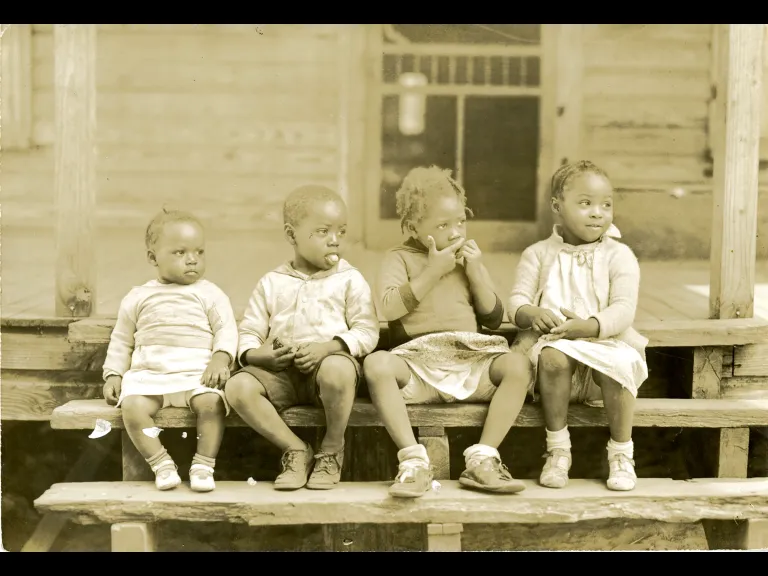 Bayard Wootten _ Black and white photo of kids sitting on a porch